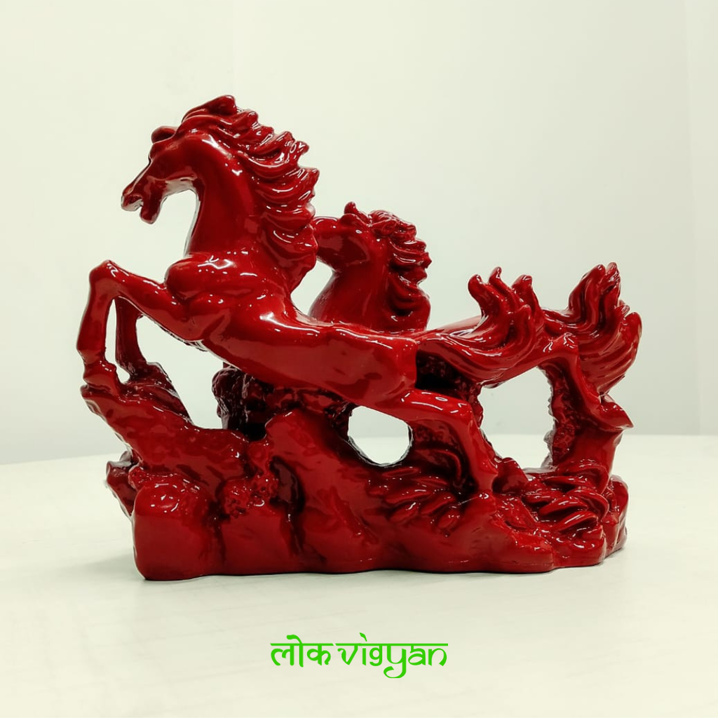 Red statue of galloping horses
