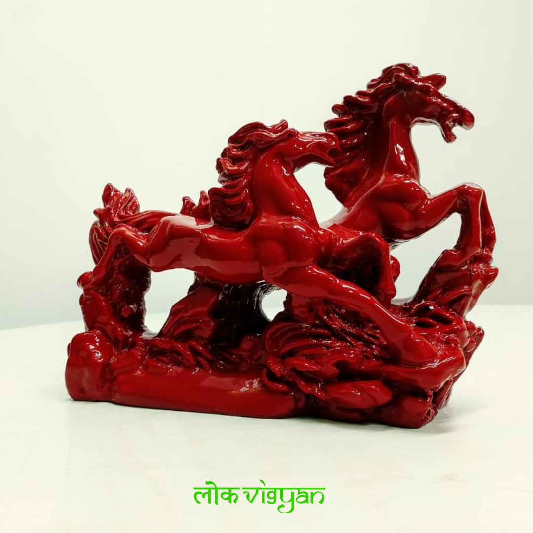 Red statue of galloping horses